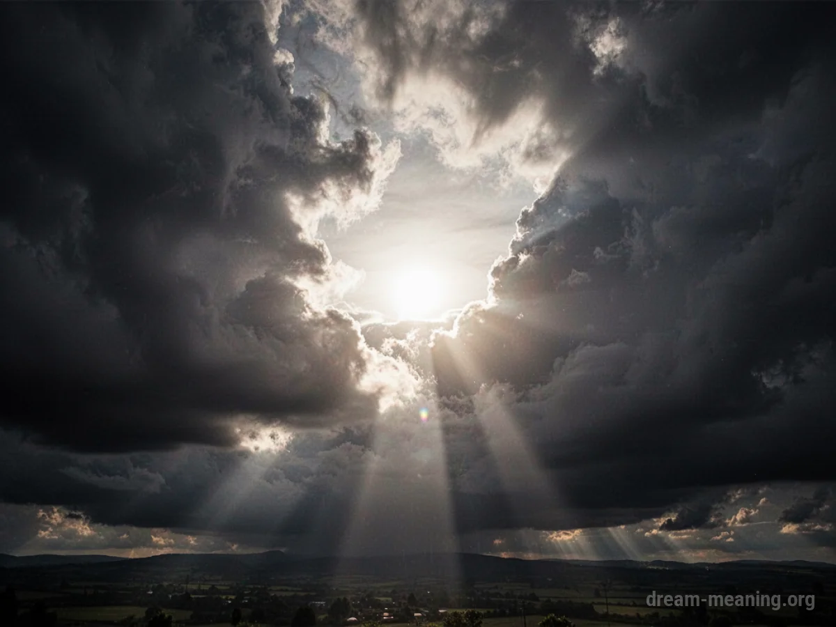 Sunlight breaking through dark storm clouds.
